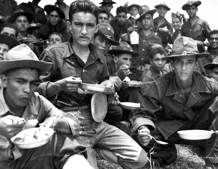 Soldiers of 65th Infantry after an all day schedule of maneuvers at Salinas, Puerto Rico. August 1941.  SC 121824